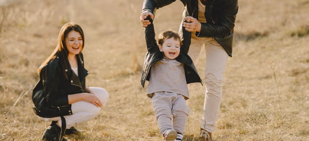 Family enjoying playful soccer game outdoors, capturing joyful moments.